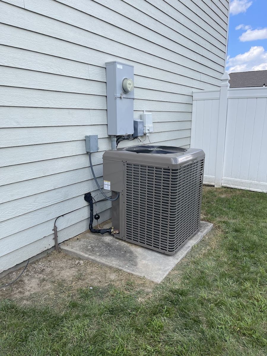 Clean outdoor AC condenser installed at a central Missouri home by Smith Central