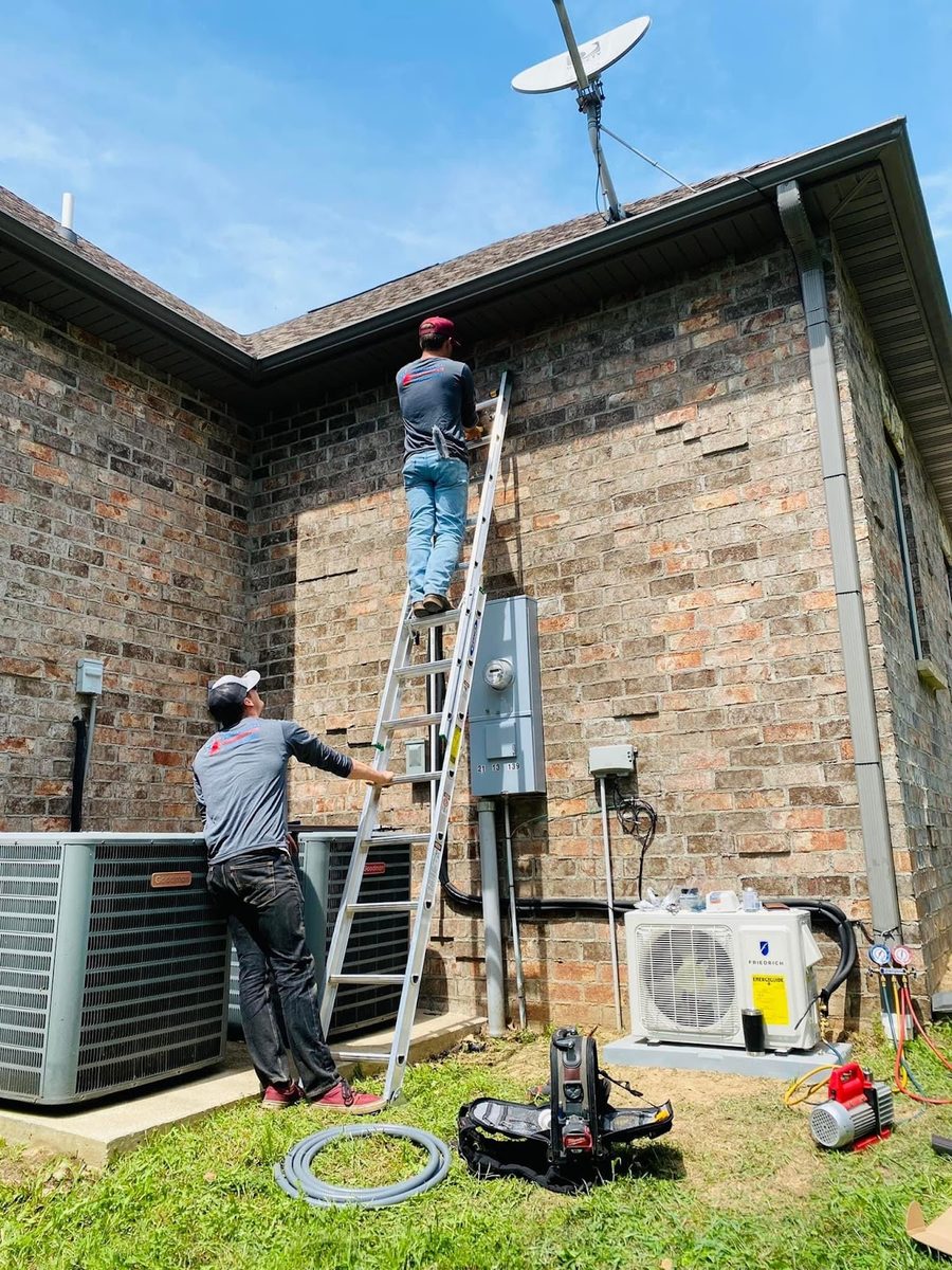 Smith Central technician working on an outdoor HVAC unit with company branding visible